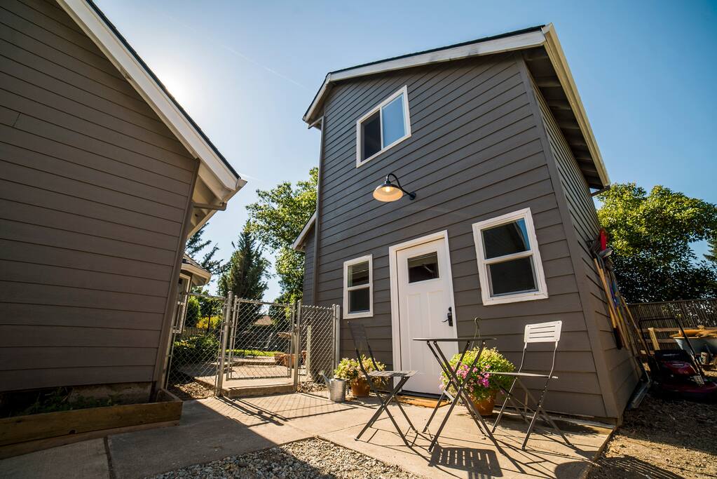 Front patio sitting area with a three piece bistro set.