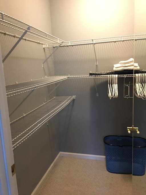 Private walk-in closet, iron & ironing board inside bedroom