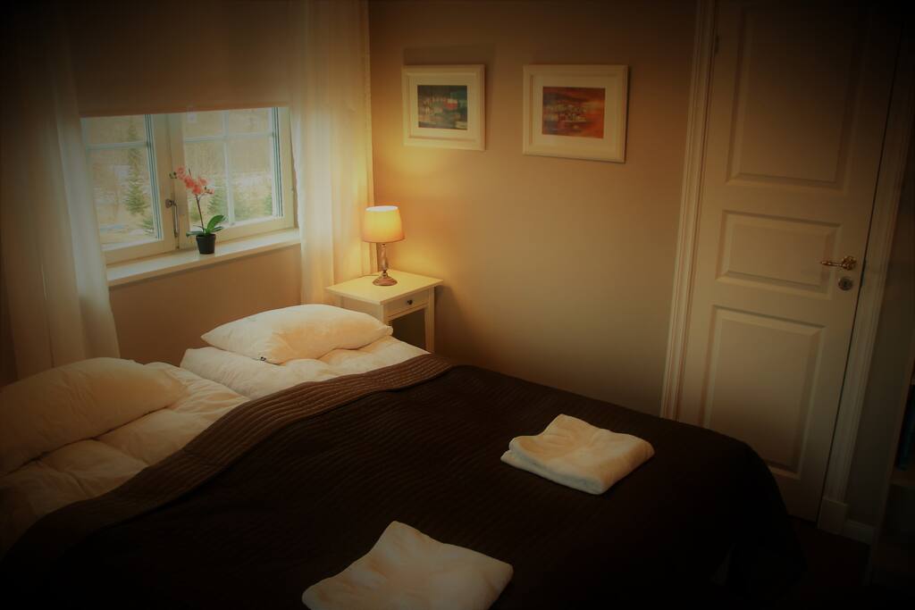 Room with bed and bathroom door