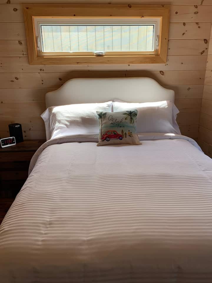"On Island Time" is how you need to be when staying in the queen bed in our Ocean Wind floating cottage.