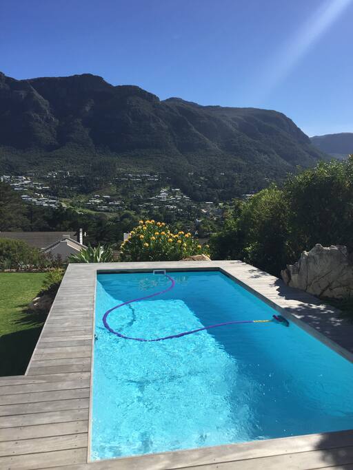 Solar heated pool leading off wooden deck