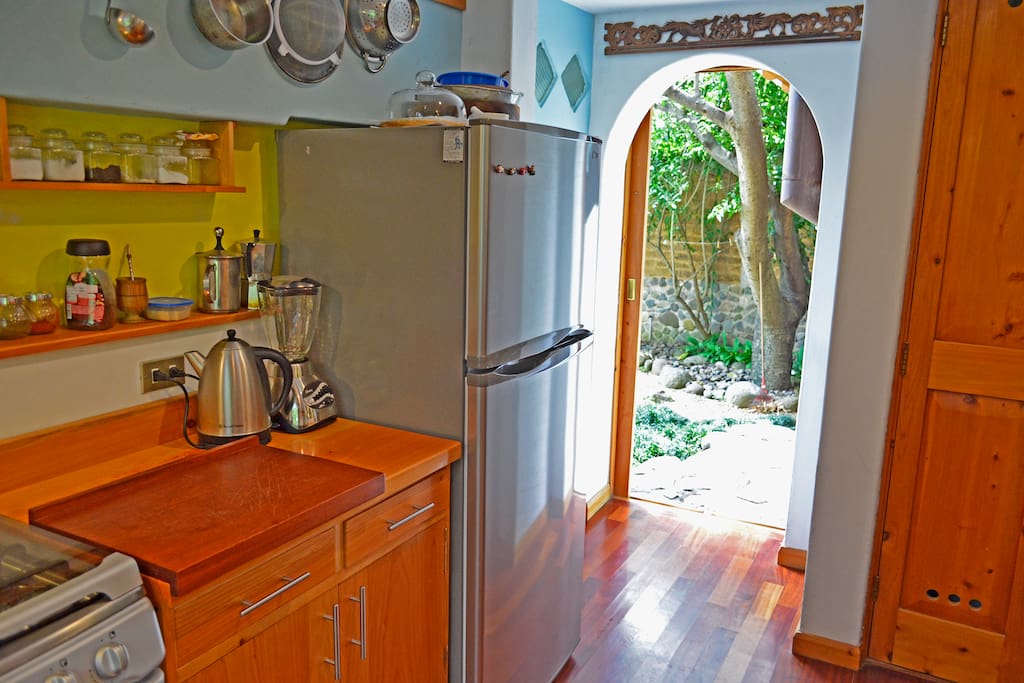 Fully equipped kitchen with full fridge, door private garden