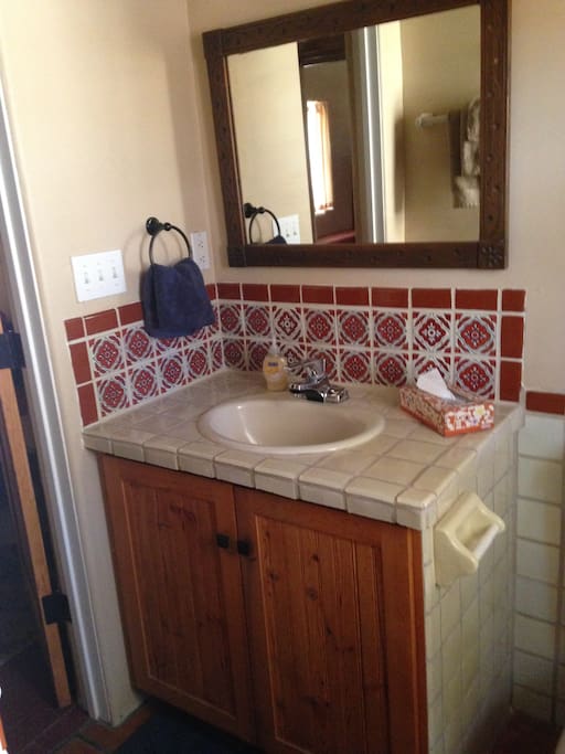 In suite bath with Mexican tile.