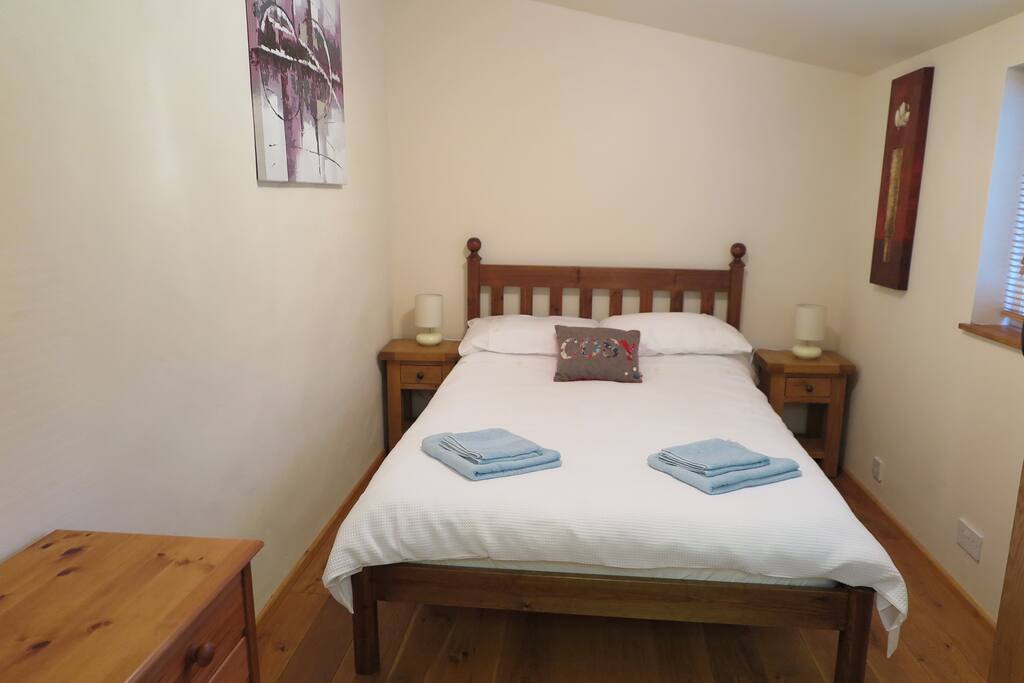Bedroom with double bed, underfloor heating, dressing table and wardrobe