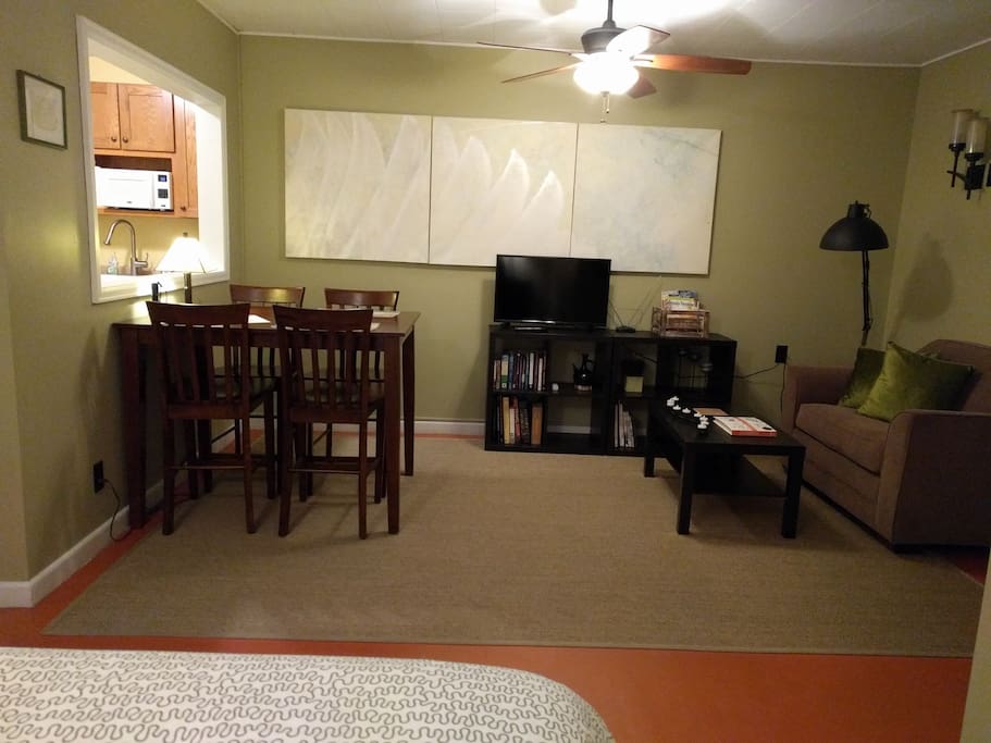 This studio apartment has a table and chairs, sofa bed, queen sized bed, kitchenette, bathroom and lots of amenities!