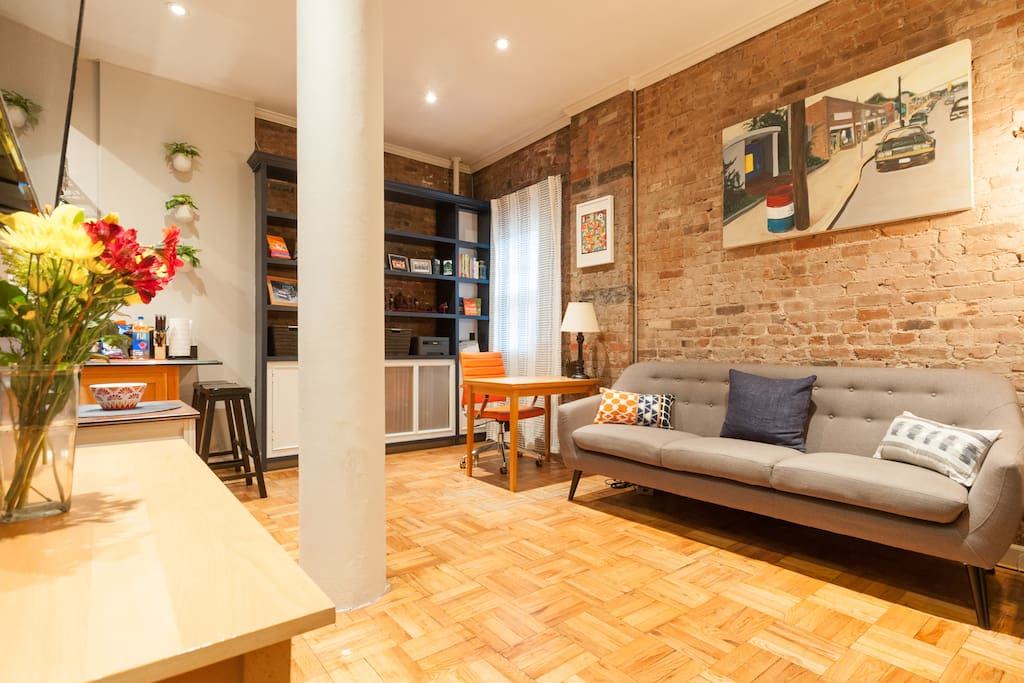 Warm, inviting home with hardwood floors and exposed brick.