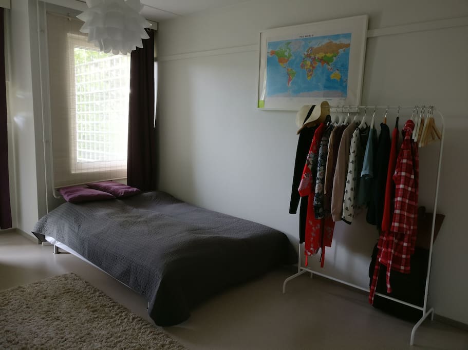 Bedroom has a clothes rack and a map, in case you're lost or searching for your next destination.