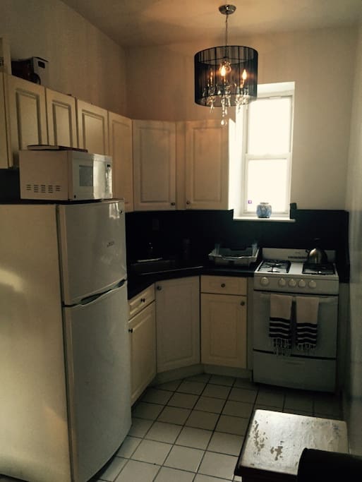 Modern kitchen with fridge, oven and stove.