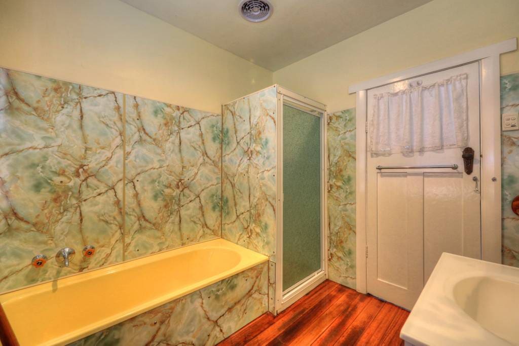 Private bathroom off house hallway