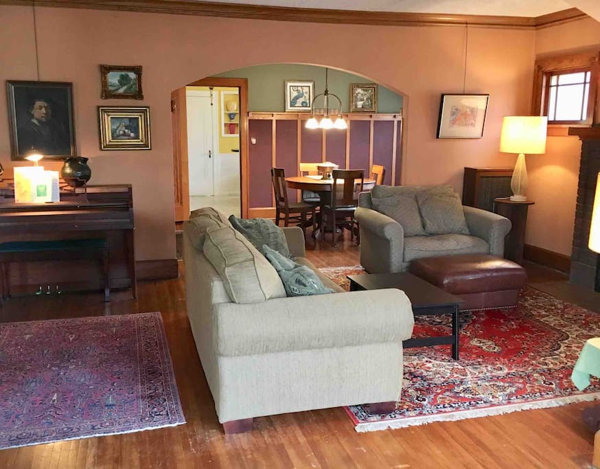Inviting Living Room with Comfortable Seating, and Piano. The Living Room naturally blends into the Arts and Crafts Dining Room with Buffet.