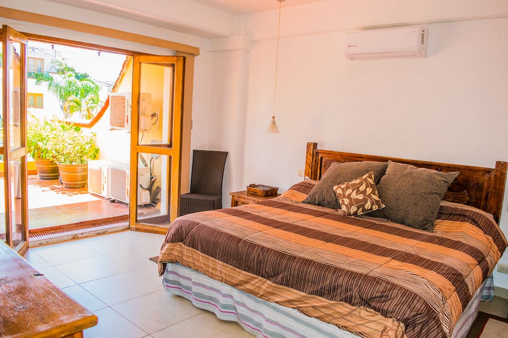 Master bedroom includes a comfortable King Size bed and the room opens right up to the massive terrace