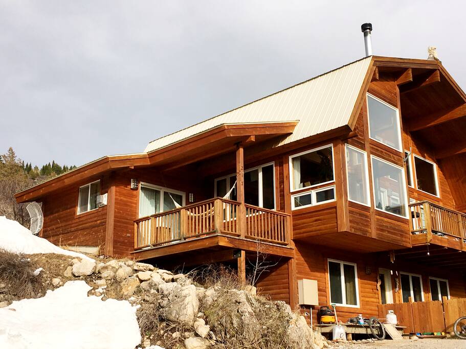 House with wrap around deck and fenced yard