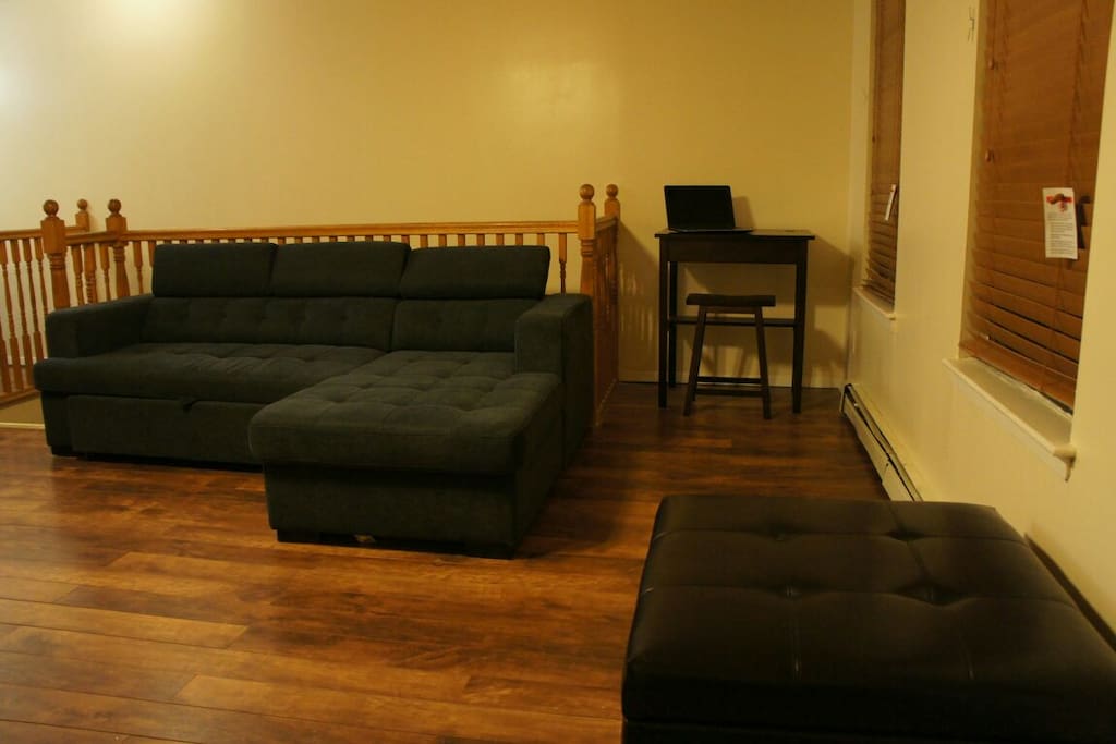 Couch that converts to sleep two. Desk and stool with available wifi.