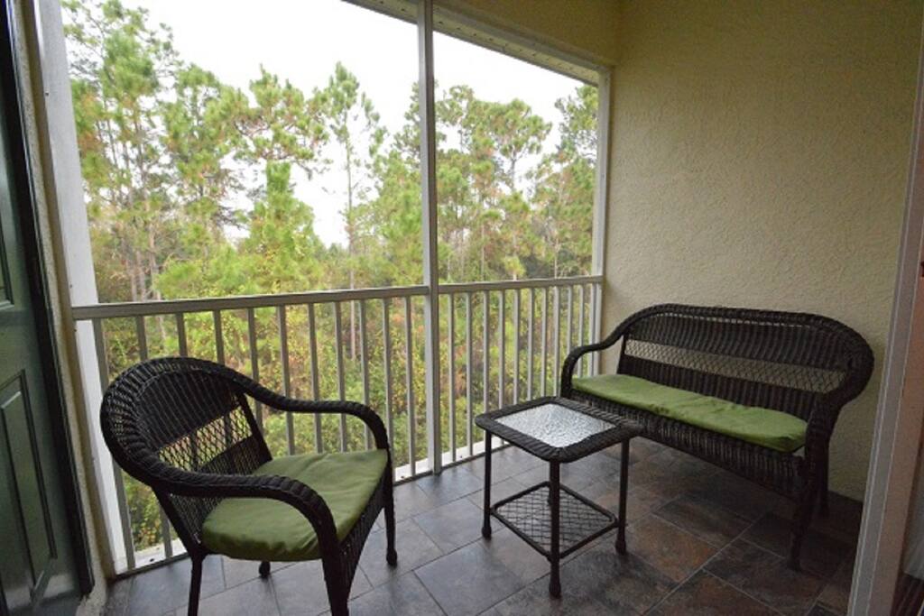 Screened balcony seating area
