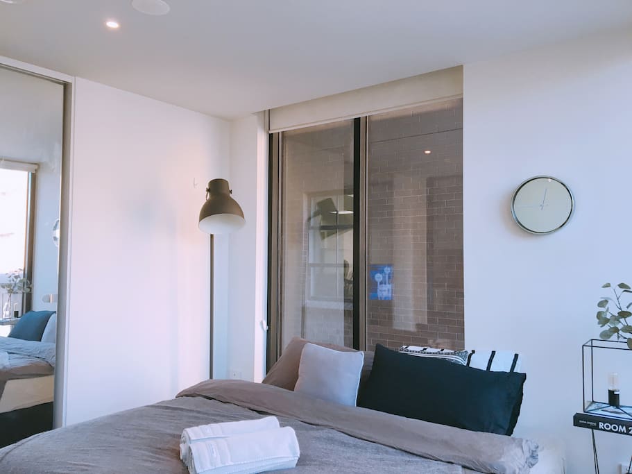 Bright room with clean soft linens and green plants