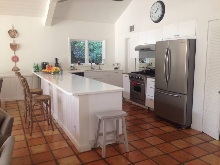 Spacious breakfast bar doubles as a roomy preparation area . We always use mats and boards for any hot pans though!!