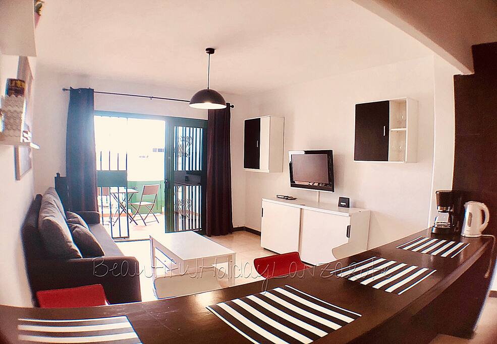 living room with satellite tv, wifi and kitchen area