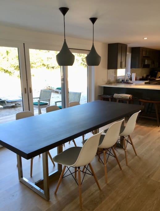 Dinning table in front of sliding glass doors to deck