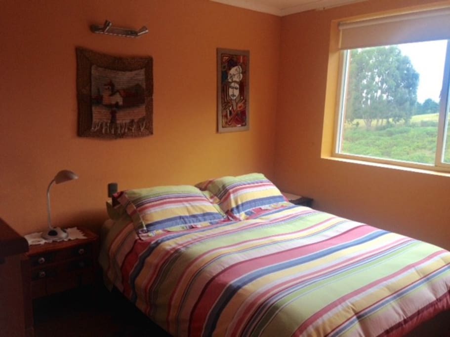 Guest bedroom with queen size bed on second floor.
