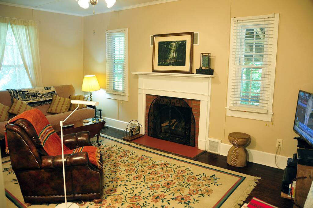Spacious living room with plenty of natural light, comfy seating, and an overstuffed futon which doubles as an extra bed!