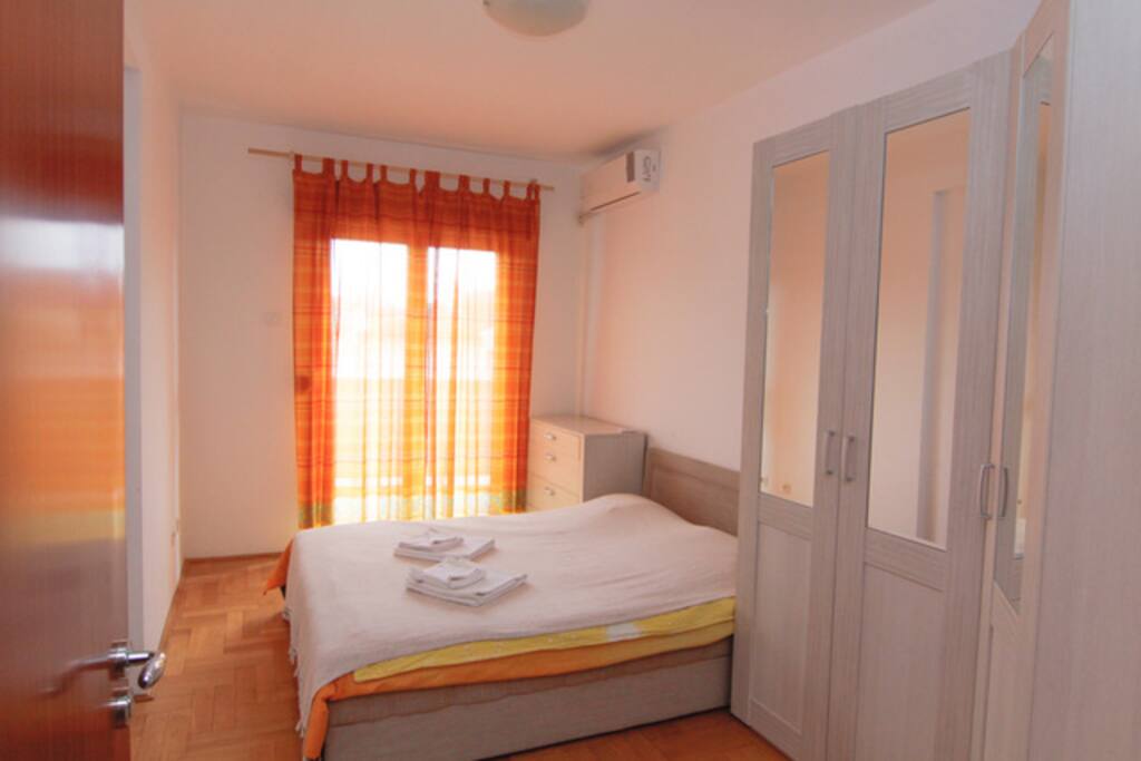 Our apartment - The bedroom with king-size bed. Access to a sea-view balcony