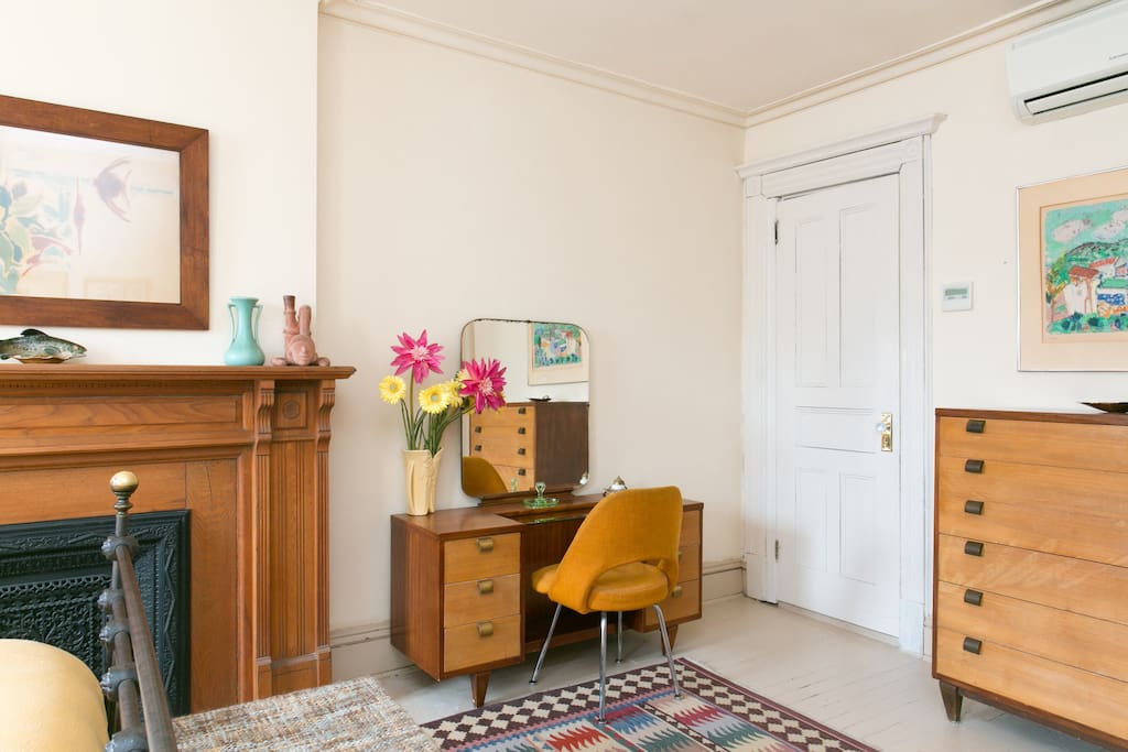 Dresser and Vanity. Door leads to half bathroom.
