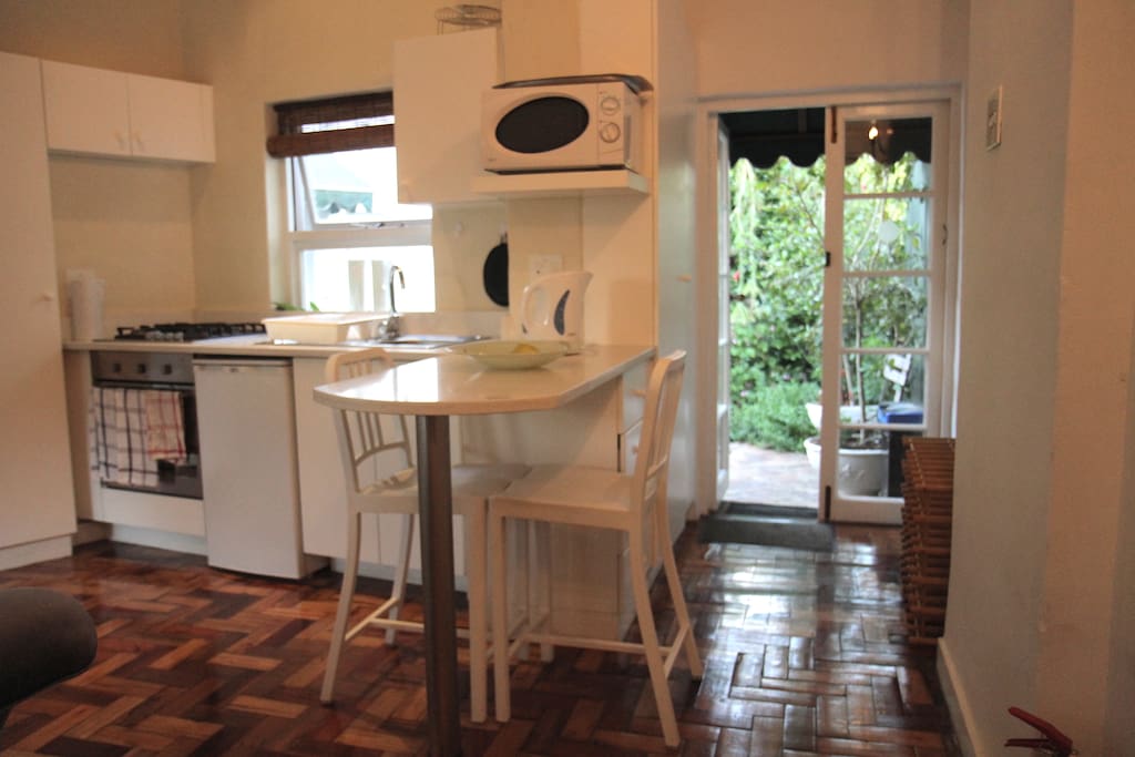 The lounge/kitchenette leading out to patio. Front door leading out to street, is behind you