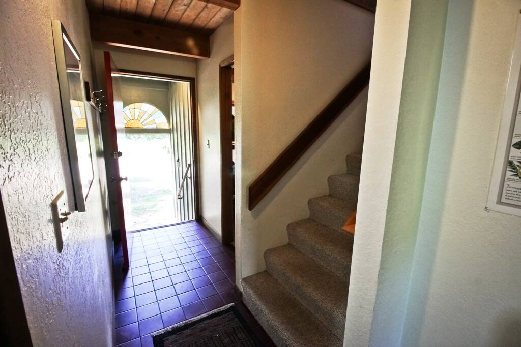 Tile entry with a small covered porch.