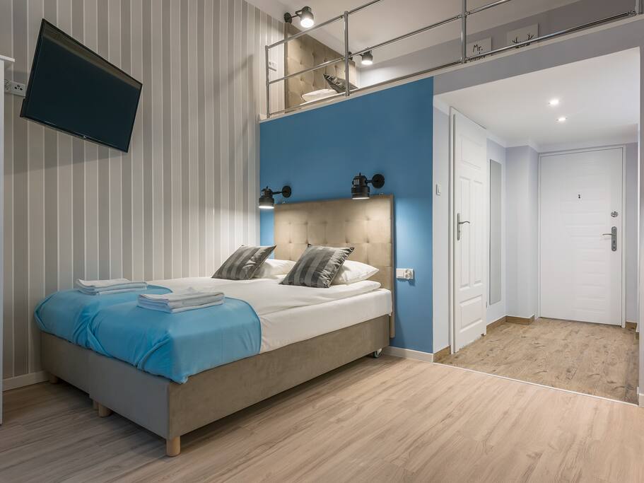 Studio with two single beds combined into large one.