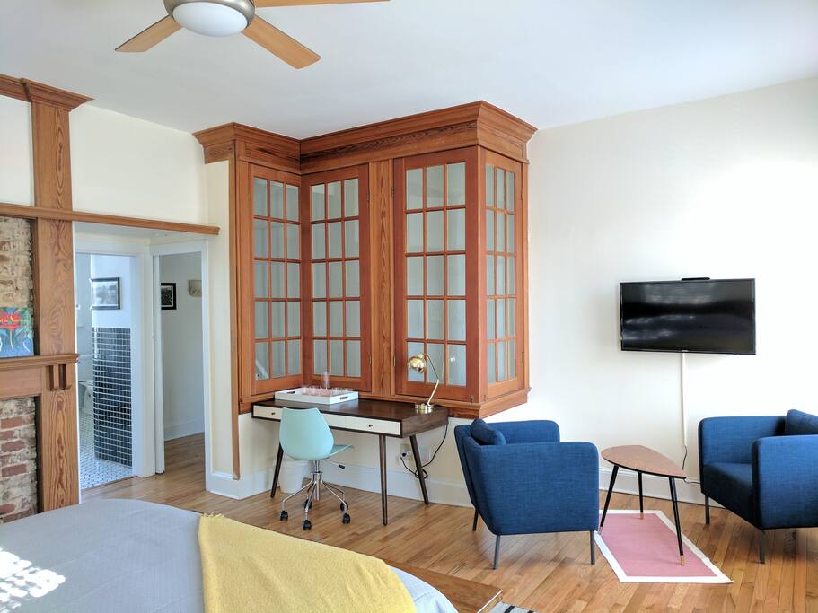 Sitting nook and desk space overlooking the room's interior windows, a special architectural detail of this historic row home.