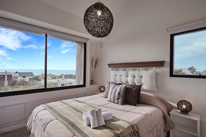 חדר שינה ראשי עם מיטה זוגית, מיזוג אוויר, אפלול וכספת.