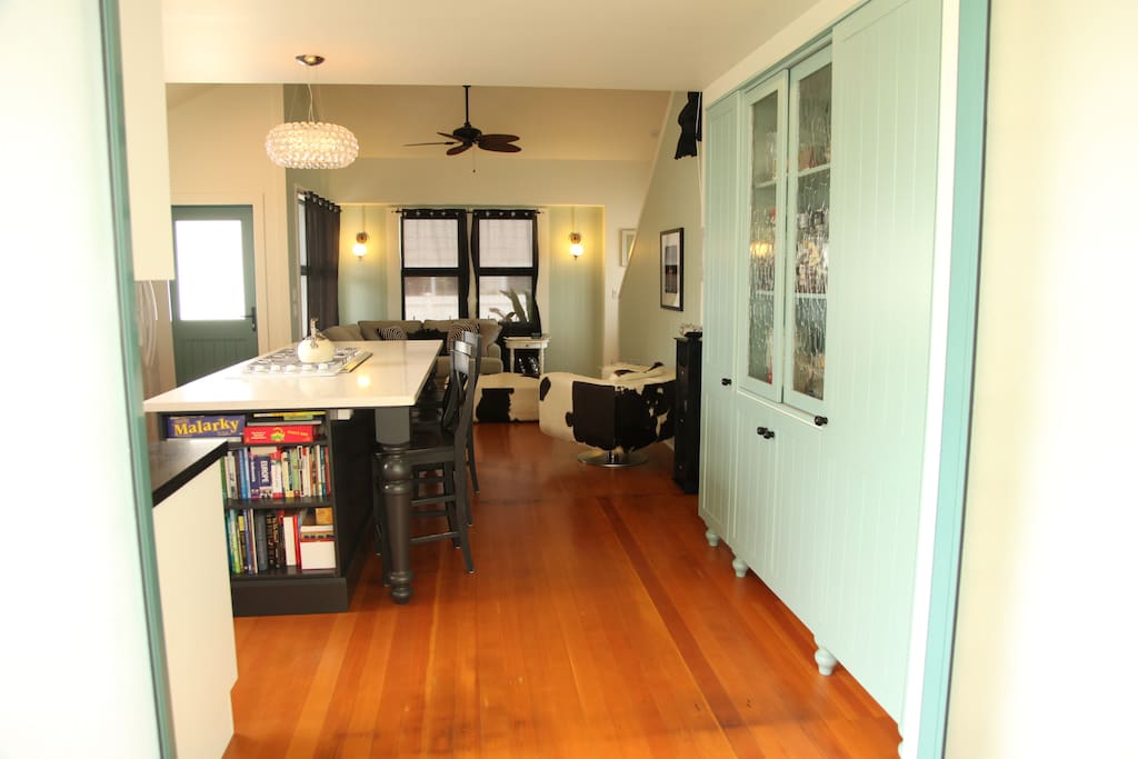 View from outdoor dining room looking into open concept kitchen and living room