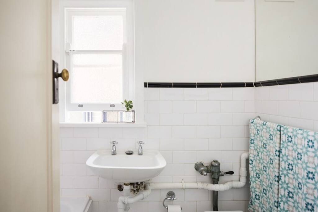 Bathroom with full bath, shower, toilet and washing machine