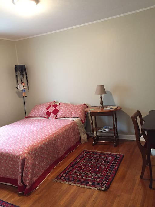 The red room features a queen sized bed.