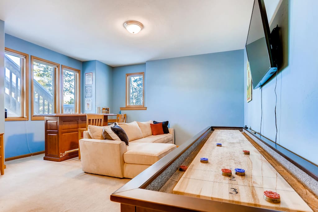 Basement - including full oak bar, 55" TV, and a brand new shuffleboard to keep everyone entertained