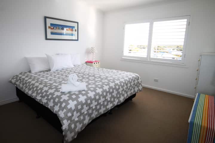 Upstairs bedroom 2, shown here as a king bed but can be 2 singles on request.