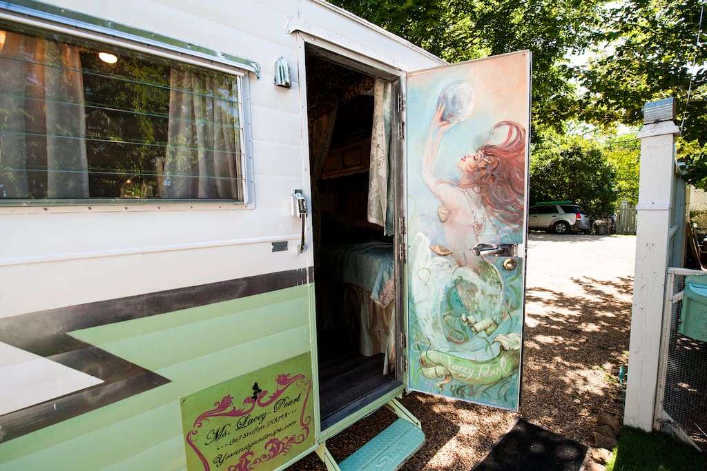 A mural of Ms. Lacey-Pearl greets you! Come visit a 5 star "MERMAID's LAIR" themed vintage trailer experience!