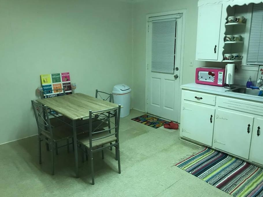 Kitchen with stove, microwave, and dishes