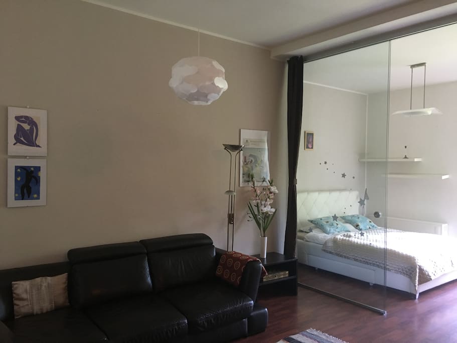 Lounge/bedroom 1 - glass door and curtains to separate bedroom space
