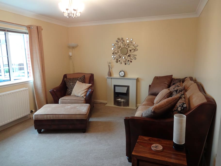 Living room with electric fireplace, flat screen TV, books, DVDs, games, music player, Sky TV, WIFI internet, DVR, central heating.