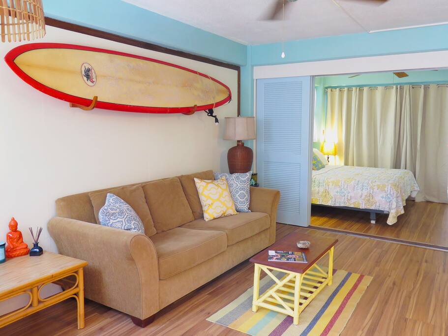 Living room with view to bedroom, surfboard is available for your use! Sofa pulls out to sleep 2