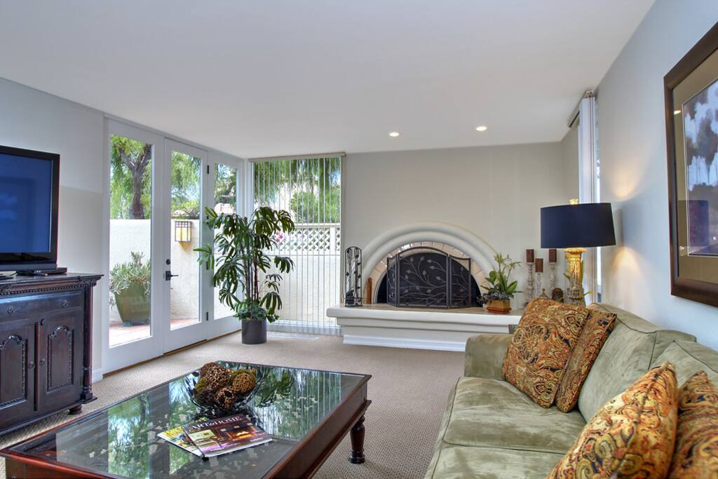 Living room is bright with lots of windows.