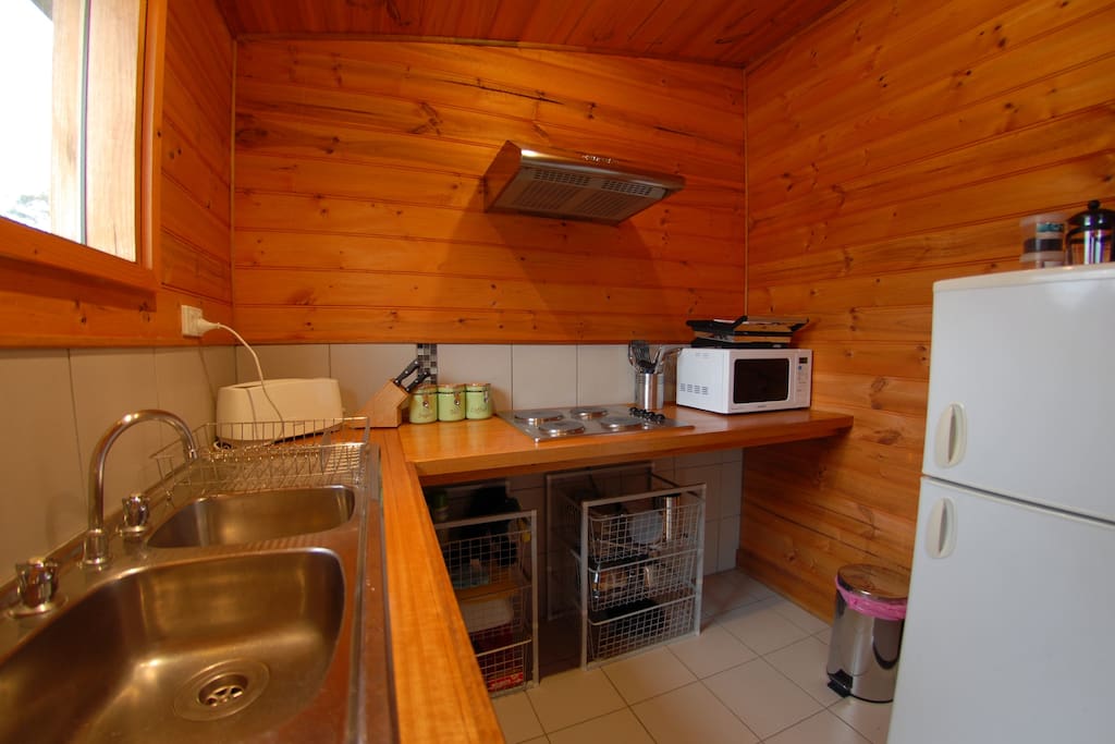 Small self contained kitchen with dishwasher, electric cooktop, microwave, fridge & coffee pod machine