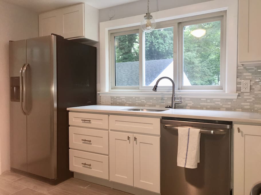 Kitchen with refrigerator, DW, microwave, range & disposal