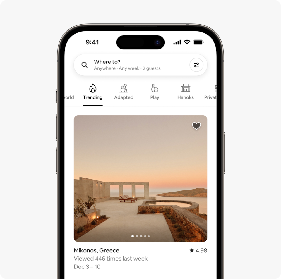 A laptop and a phone show the Airbnb homepage with two rows of homes from a new Airbnb Winter Release category called Trending, which features homes that are getting a lot of views recently.