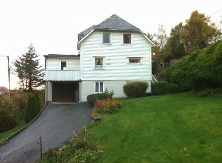From east. Guest room windows upstairs.
Car parking by the road