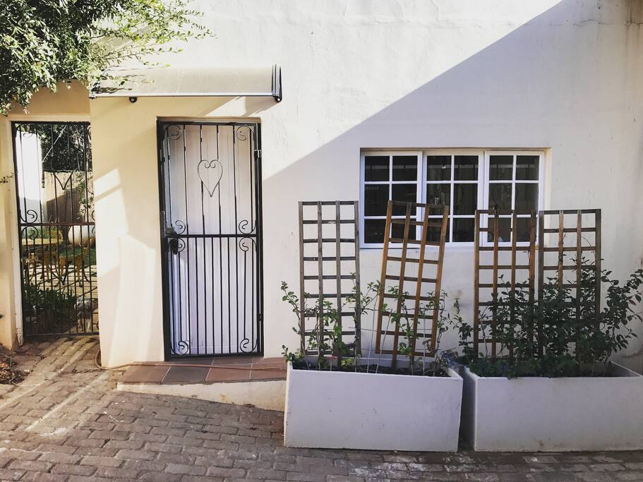 A private entrance that shares the parking area with the main house. Gate to the left leads to the private garden.