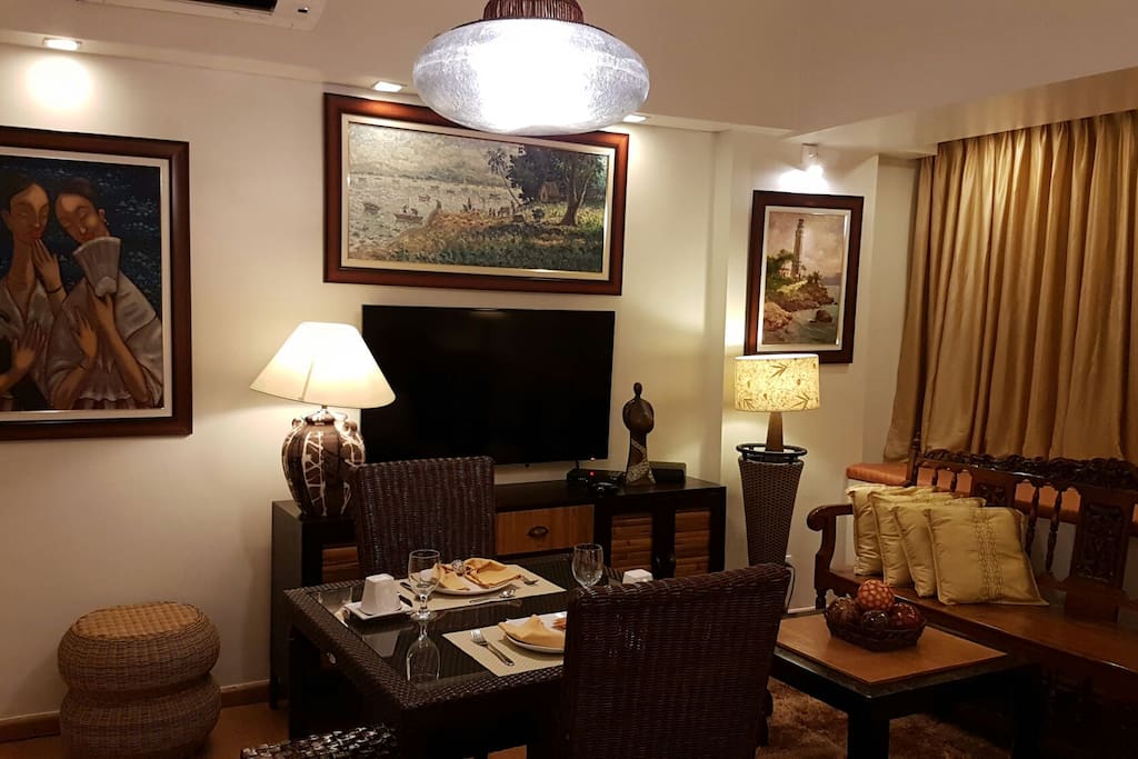 Dining table for 4, LED HD 54" TV with HD cable subscriptions, console table, and antique sofa.