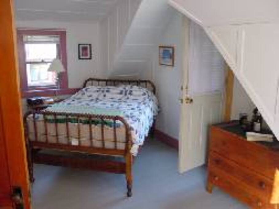 Main bedroom with a double bed. Door to second floor balcony.