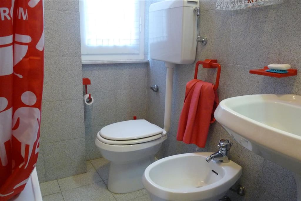 Bathroom with small bath tub shower over and ful suite.